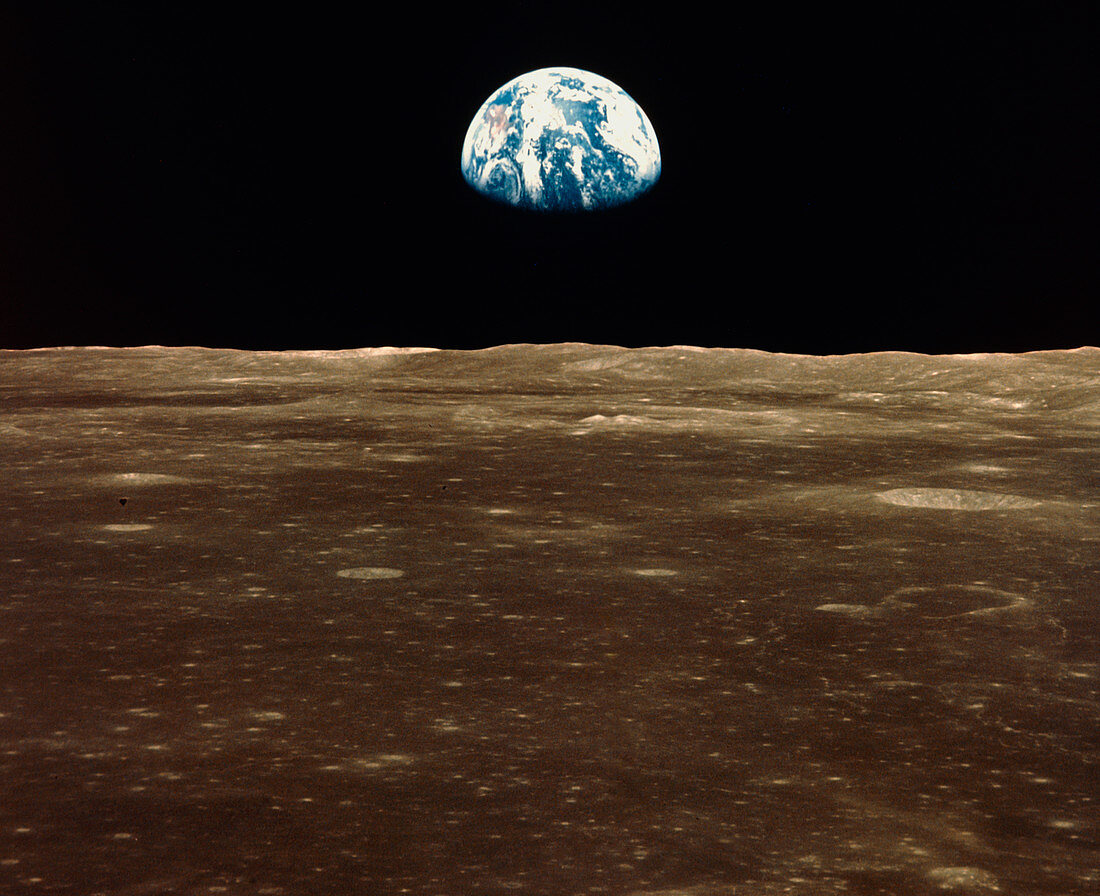 Apollo 11 view of Earth rising above lunar horizon