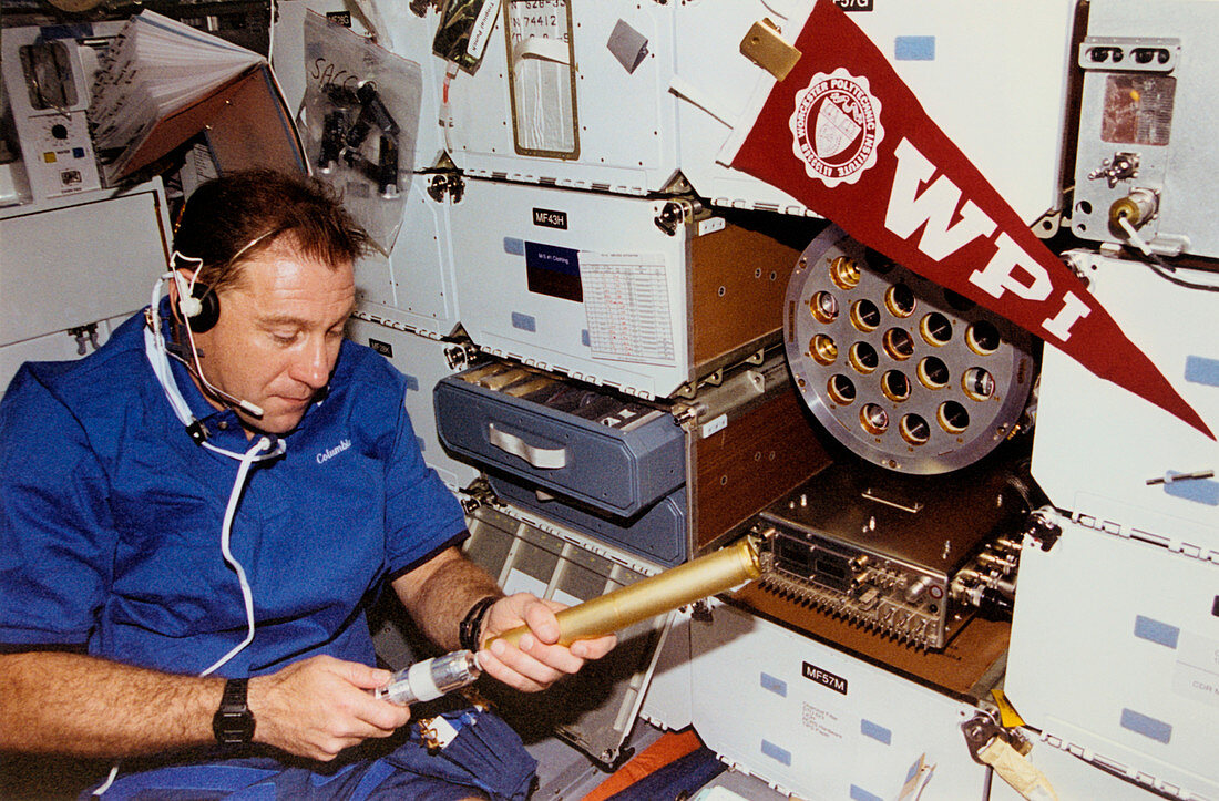 Astronaut experimenting on board the shuttle