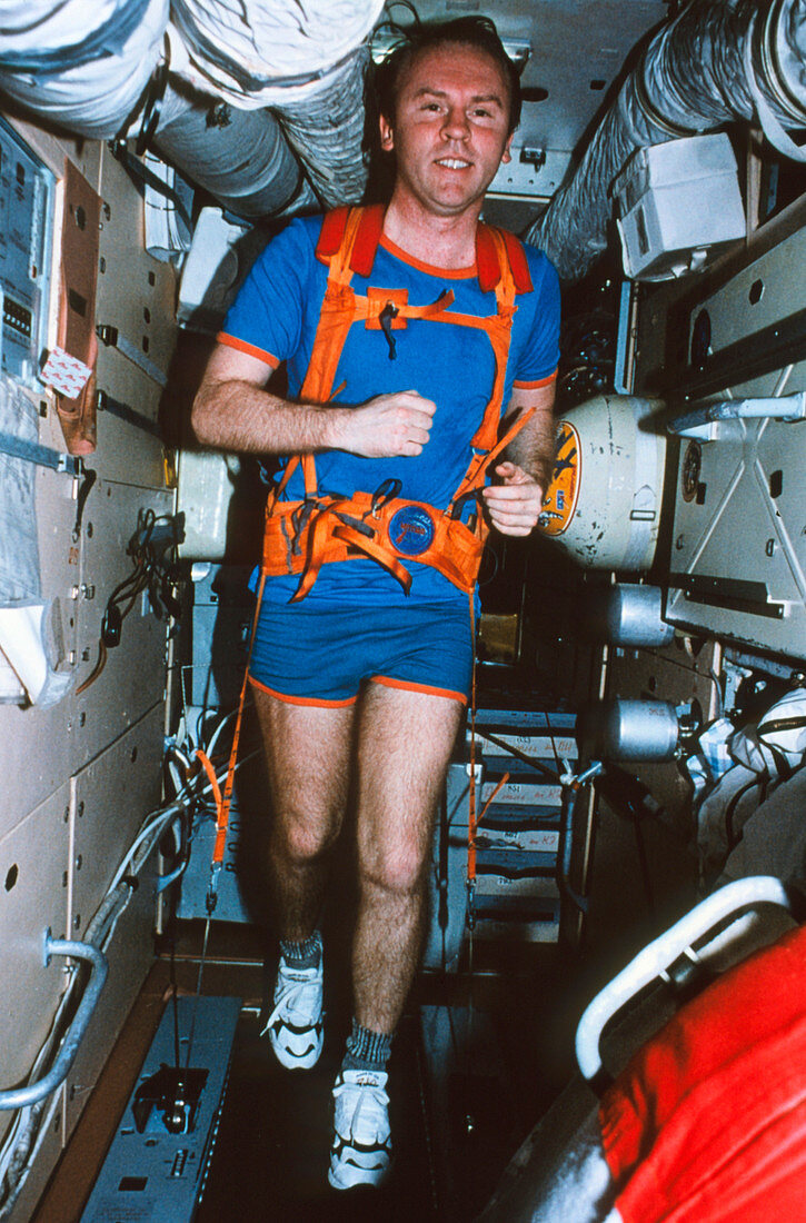Astronaut uses a treadmill on board Mir