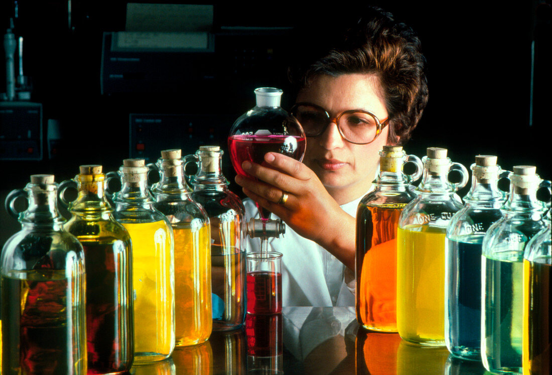 Technician with containers of oil samples
