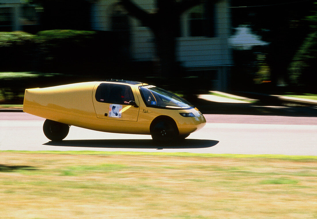 Solar powered car drives down a road