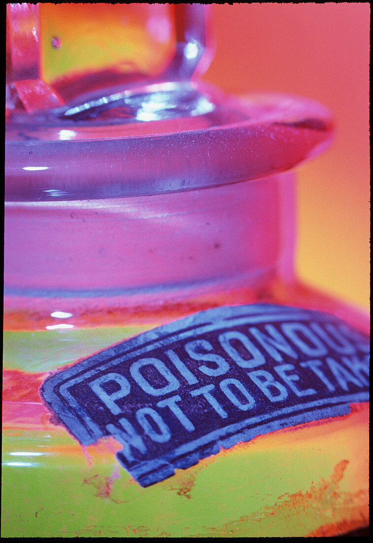 Poison warning sign on a bottle