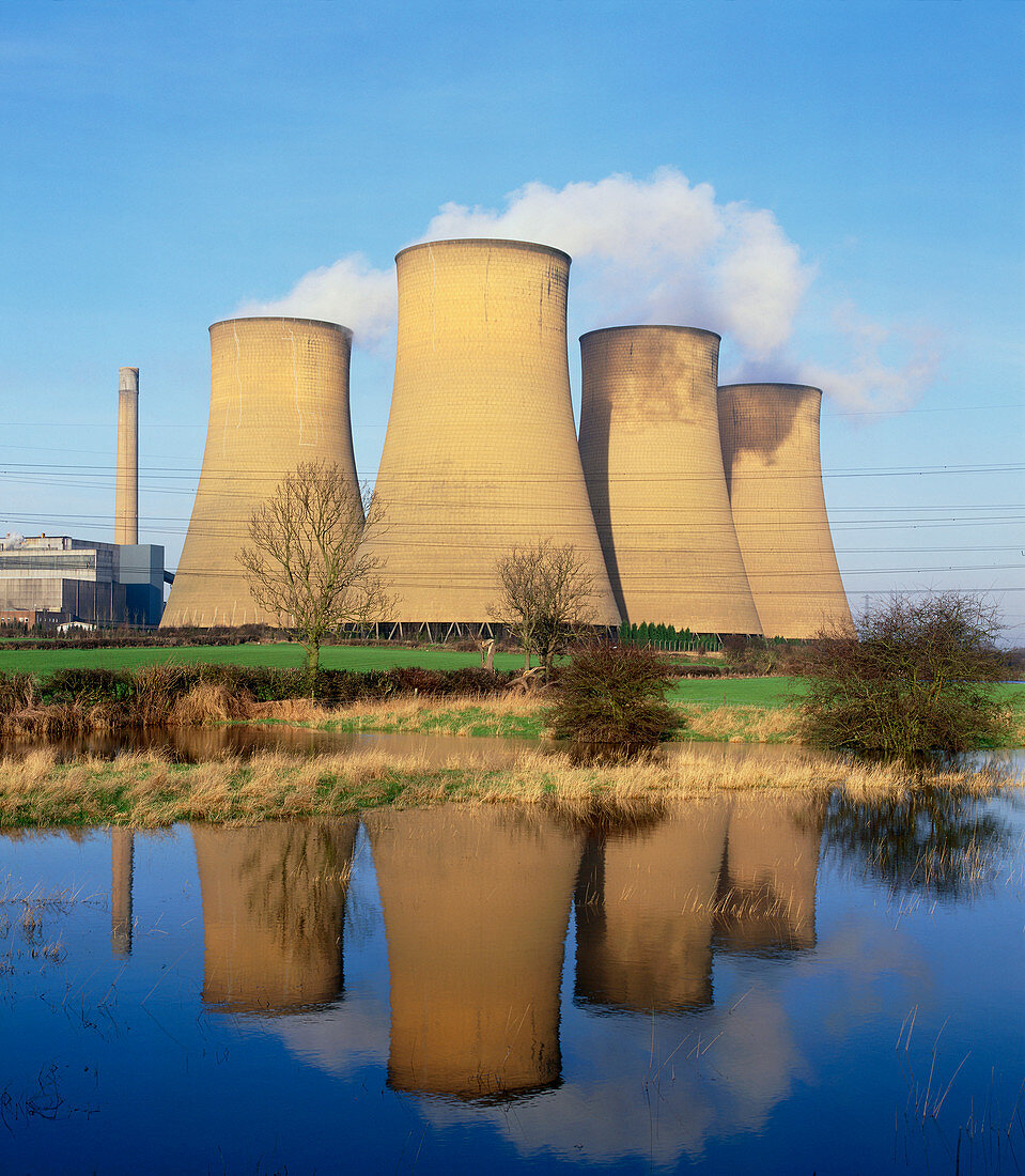 View of a power station reflected in flooded field