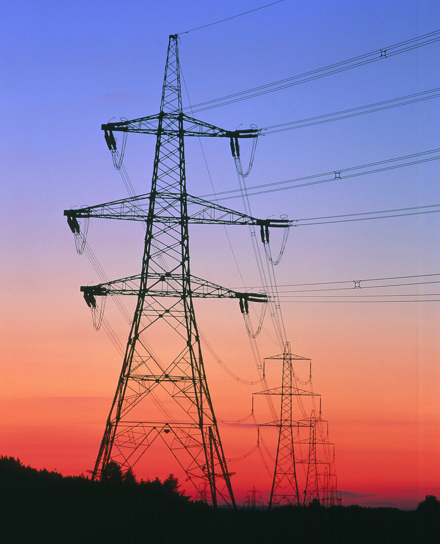 Electricity pylons & transmission lines at sunset