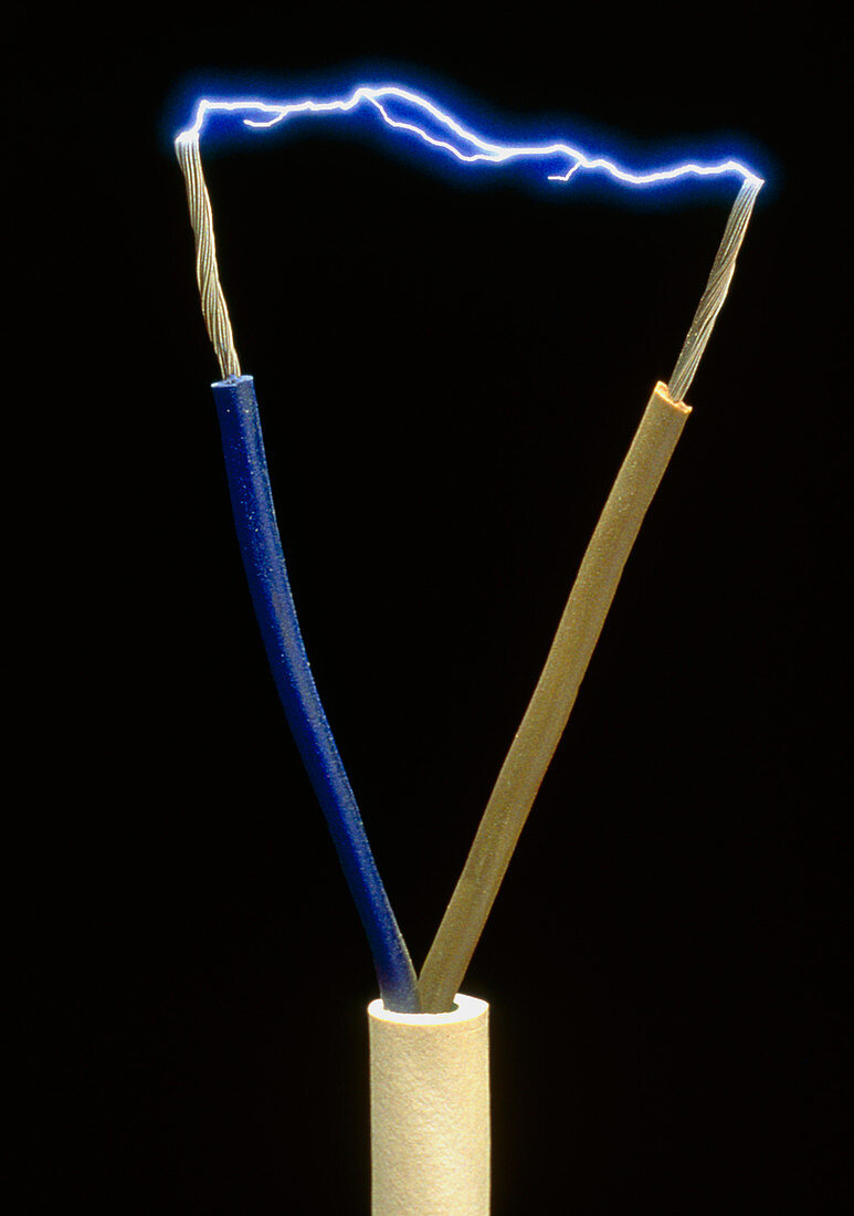 Two wires of a plug showing spark discharge