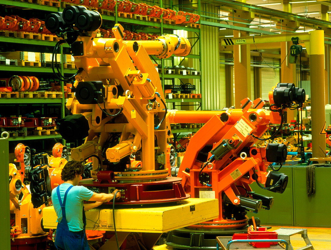 Technician assembling industrial robots