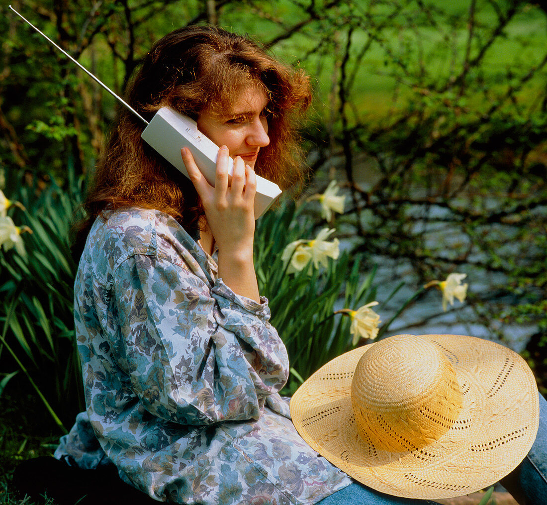 A woman using a cordless telephone