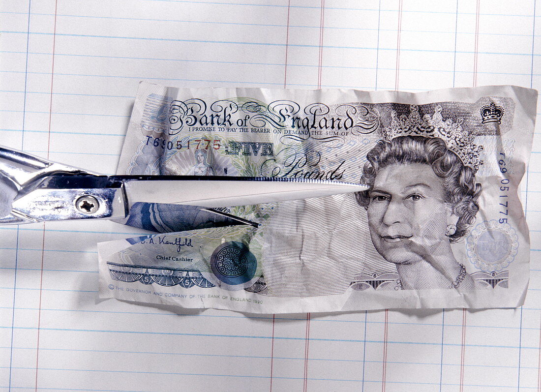 Cutting a five pound note