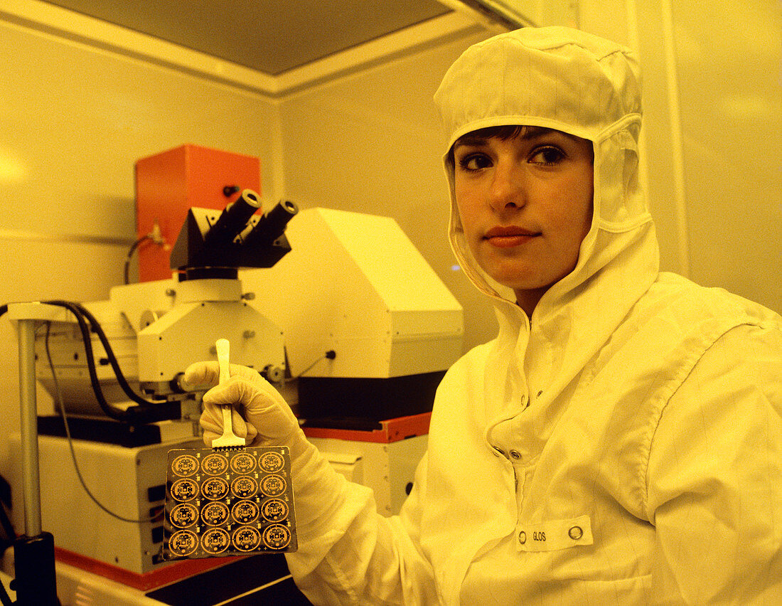 Technician with newly-made integrated circuits