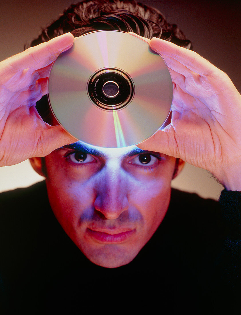 Abstract image of man holding up a CD-ROM disk