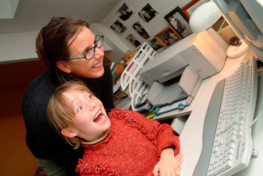 Mother and daughter at a home computer