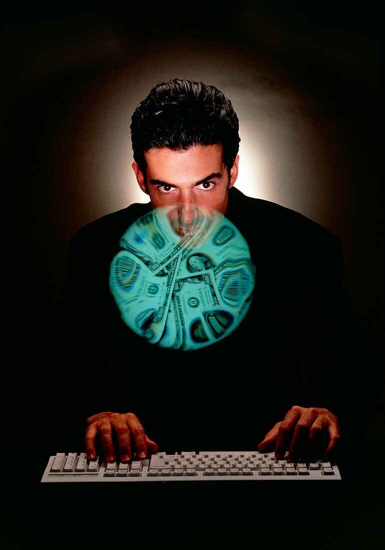 Businessman at computer keyboard & money abstract