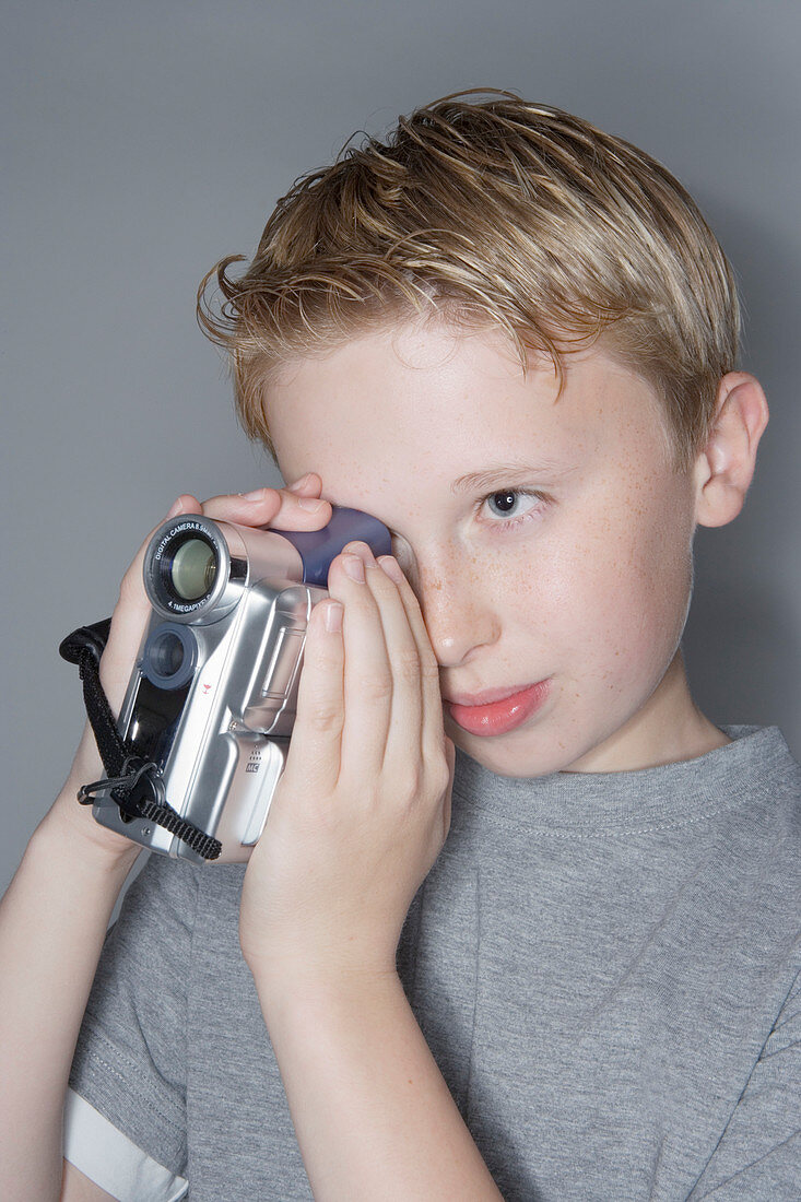 Boy using a digital camcorder