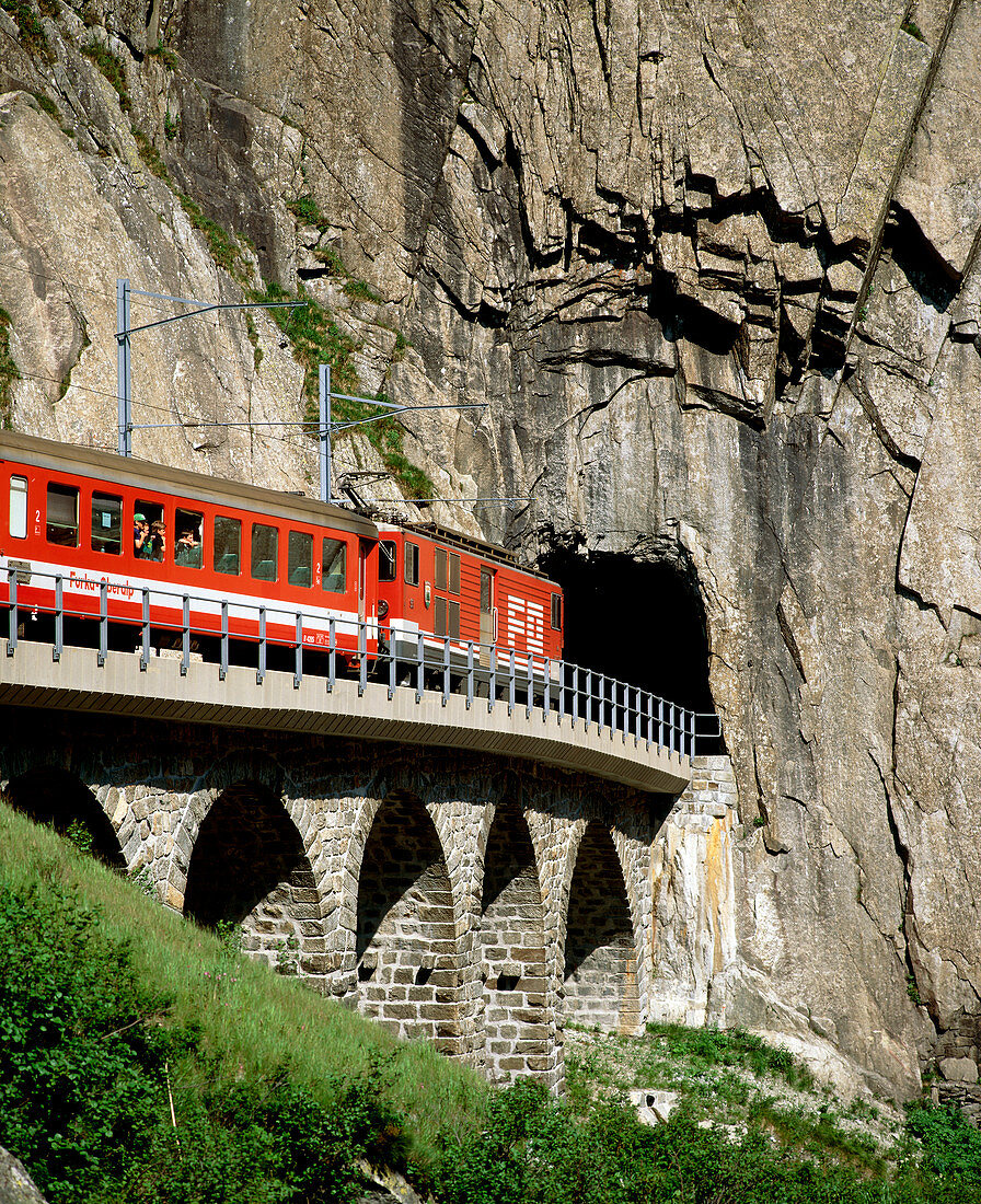 Train and tunnel in a granite gorge,Switzerland
