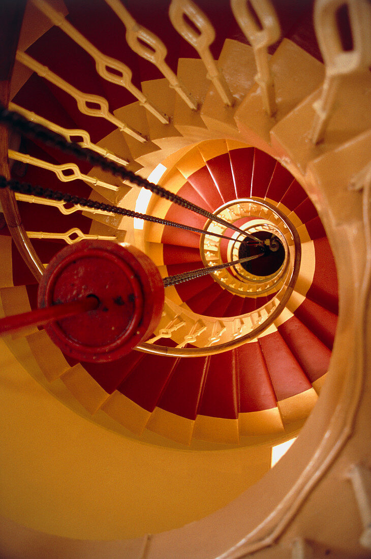 View down lighthouse stairs showing lantern weight