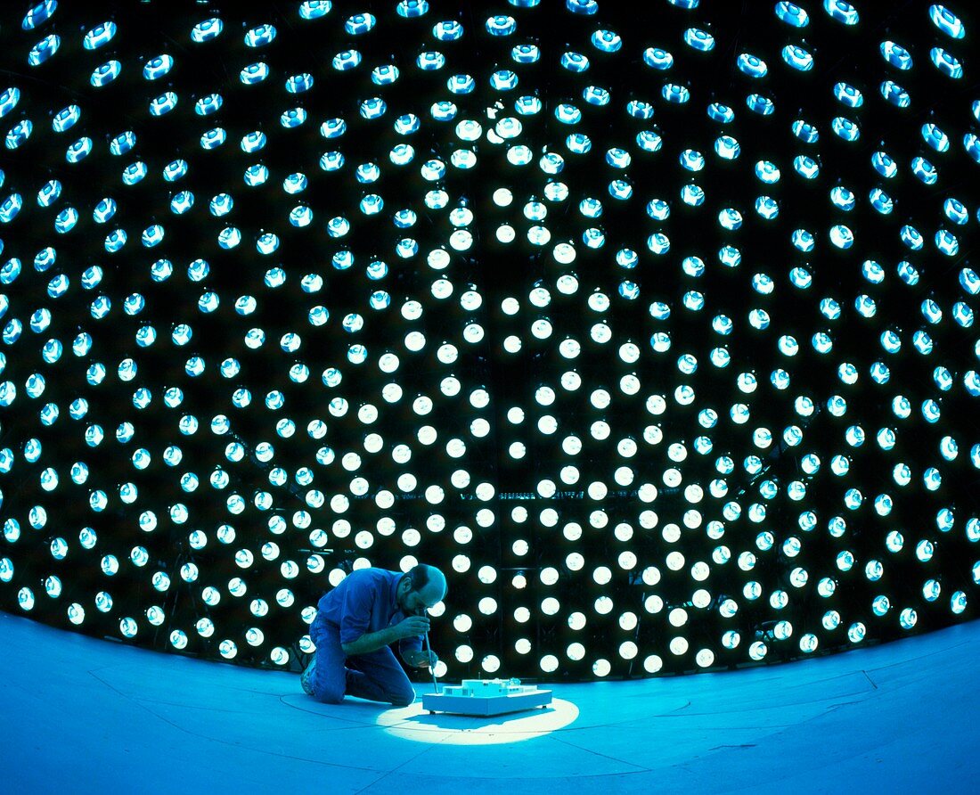 Technician examines model under artificial sky