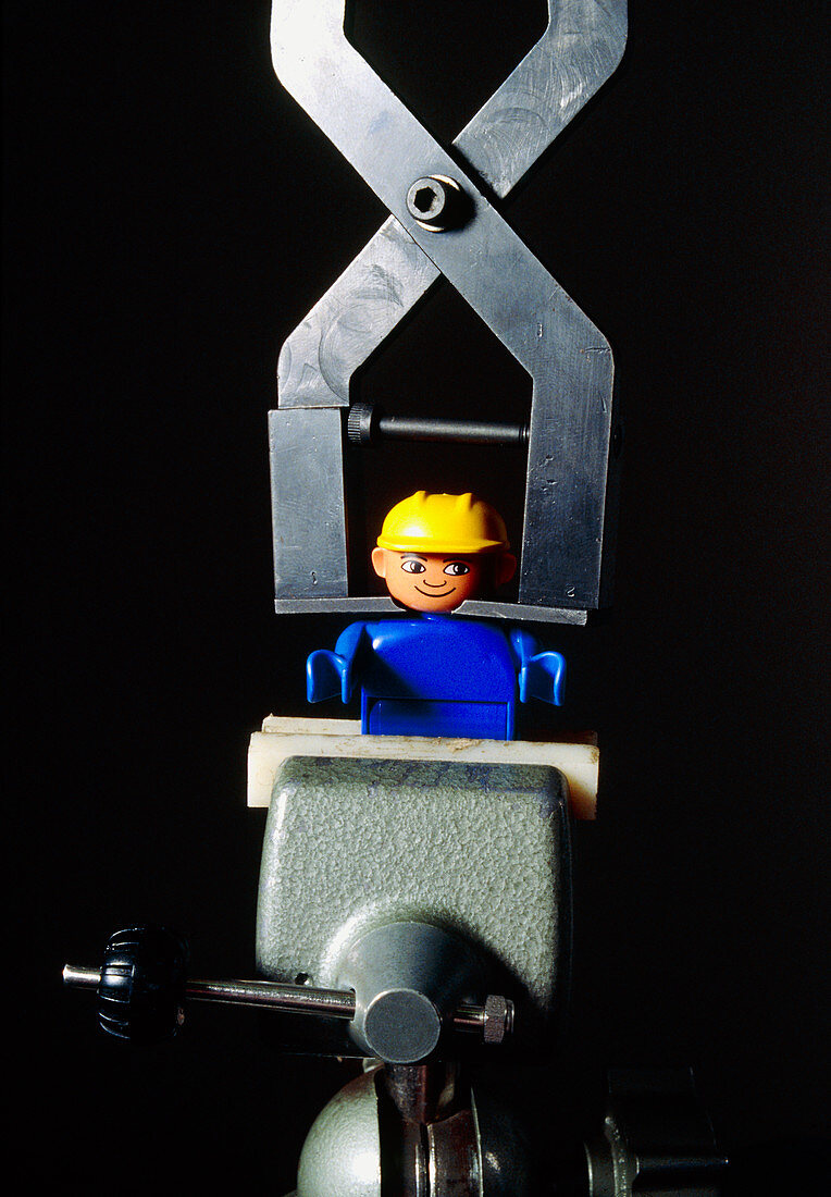 Lego toy in a vice as part of a safety test
