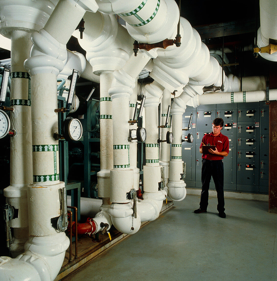 Technician with air conditioning ducts