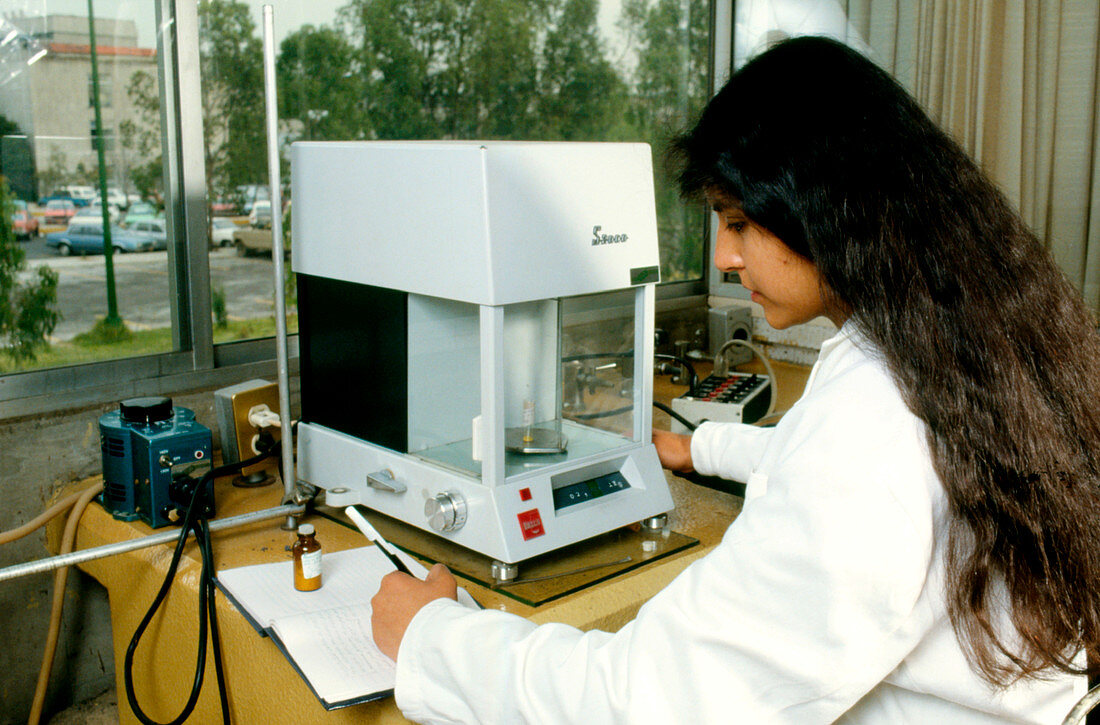 Chemist with laboratory scales