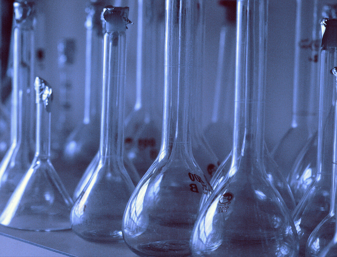 Volumetric flasks and a funnel in a laboratory