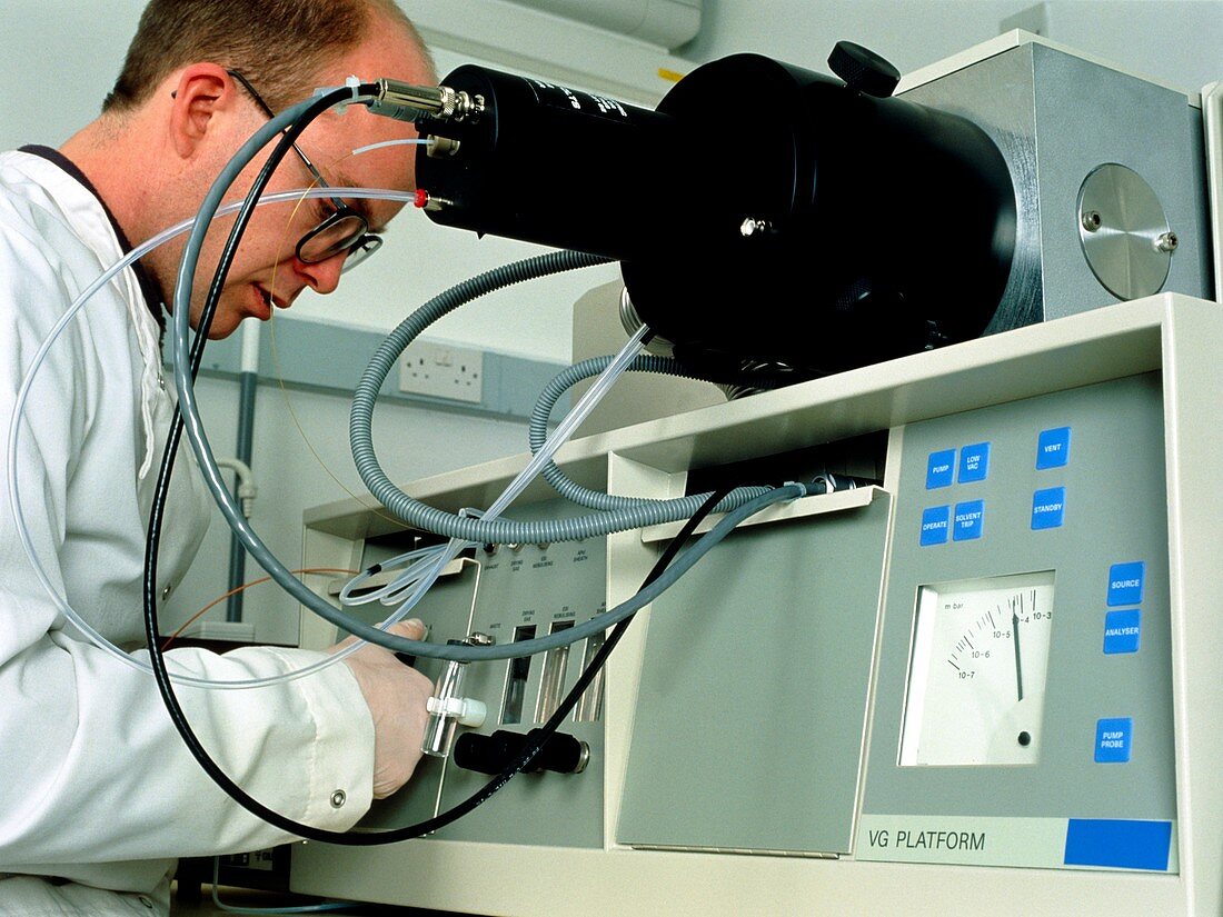 Technician using a mass spectrometer