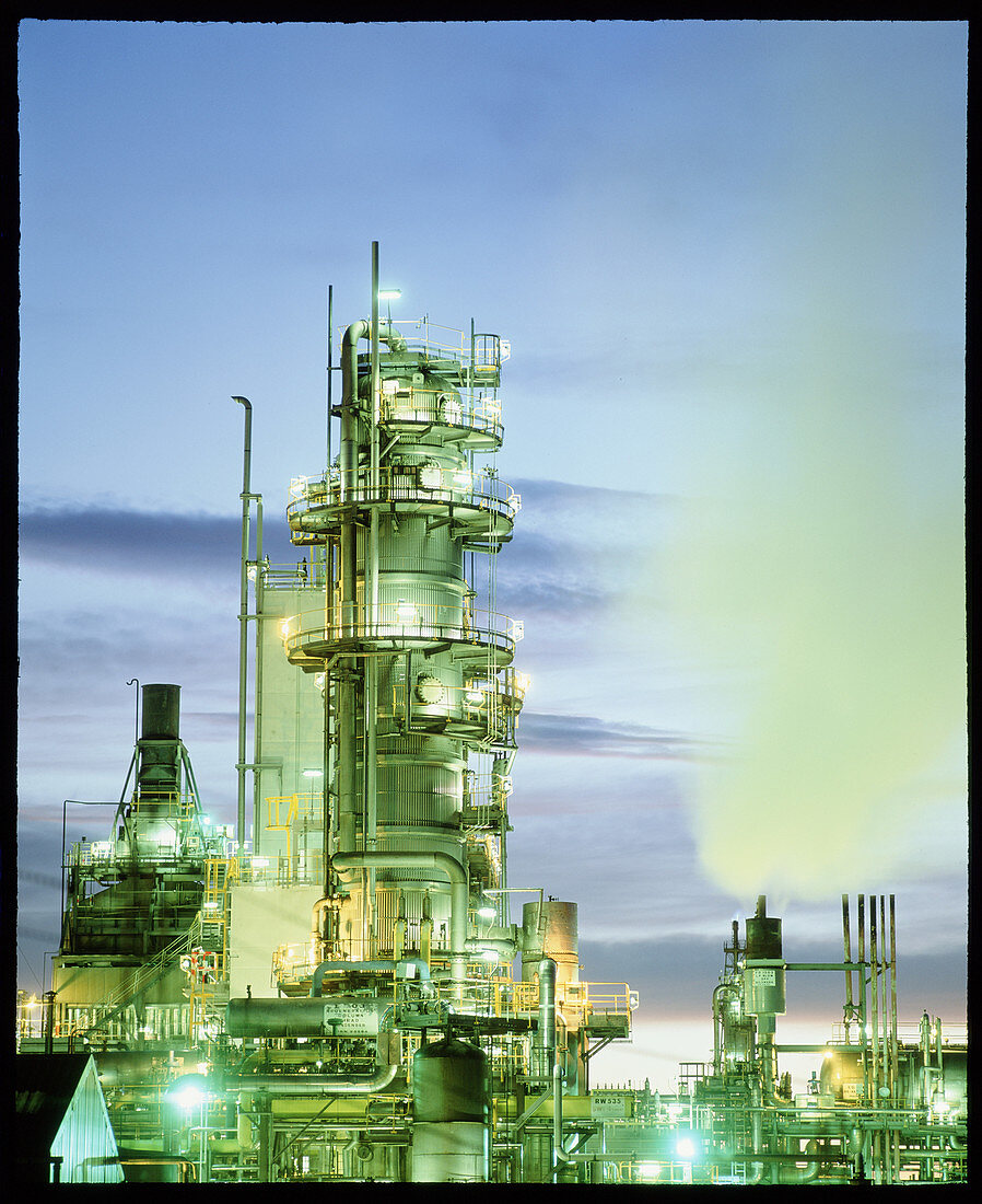 Reactor towers at a chemical plant at dusk