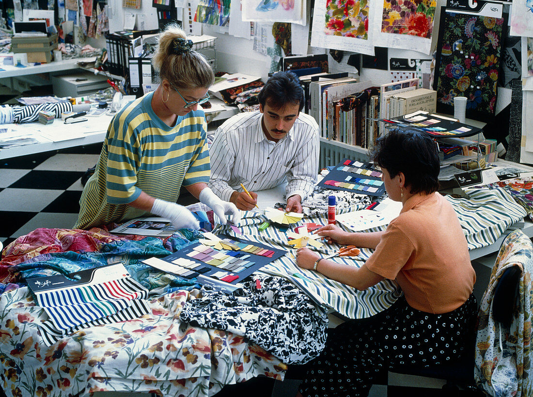 Textile designers at work with fabric samples