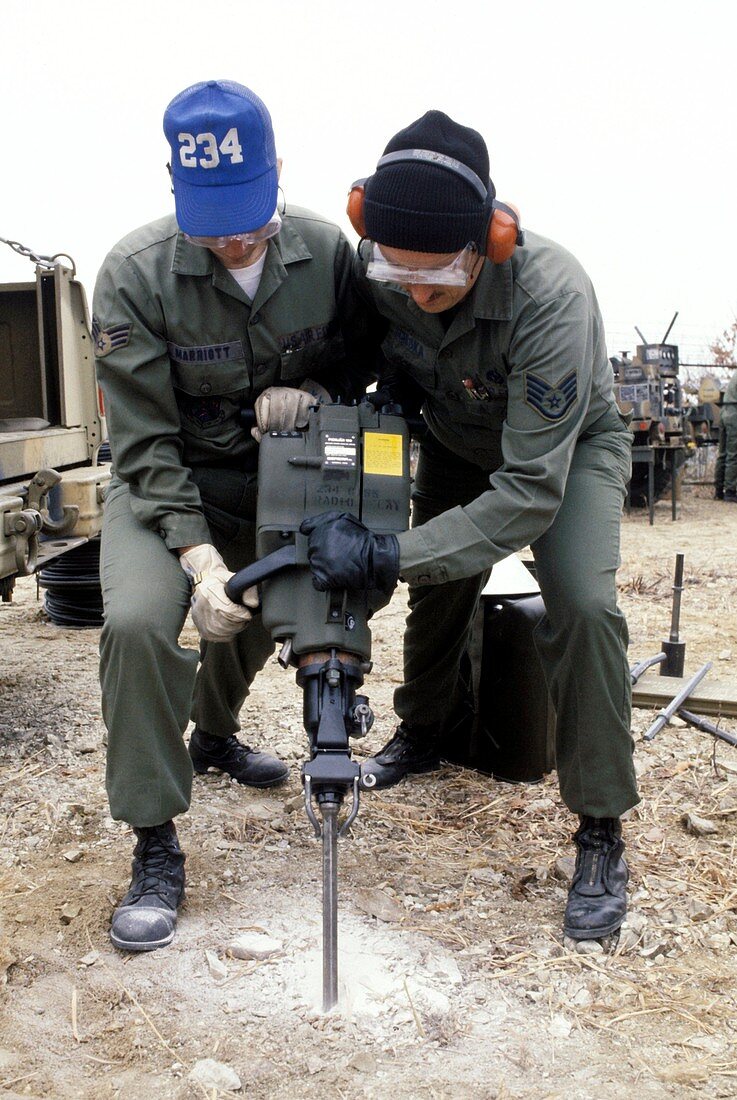 Soldiers using a pneumatic drill