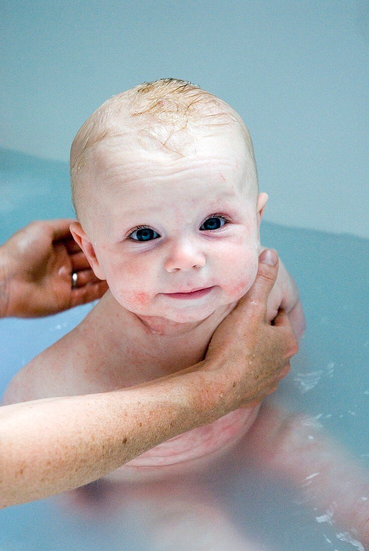 Baby boy being bathed