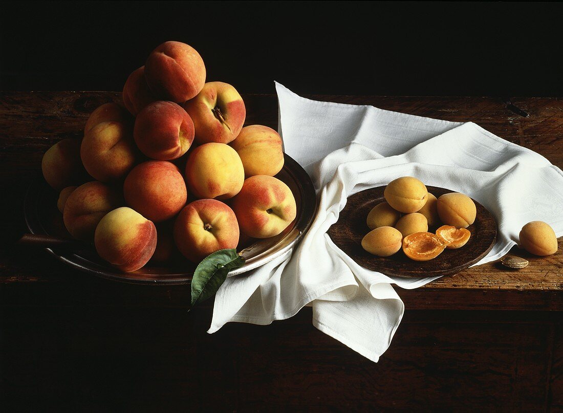 Peaches in a Bowl and Apricots on a Wood Plate