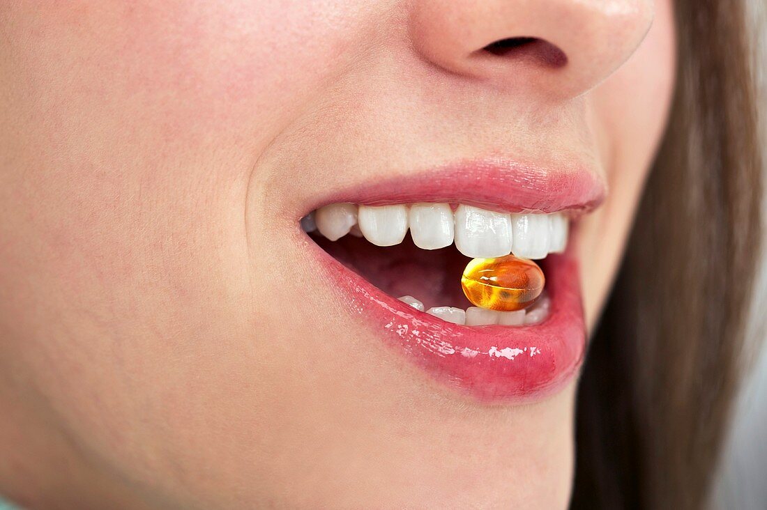Woman taking a dietary supplement