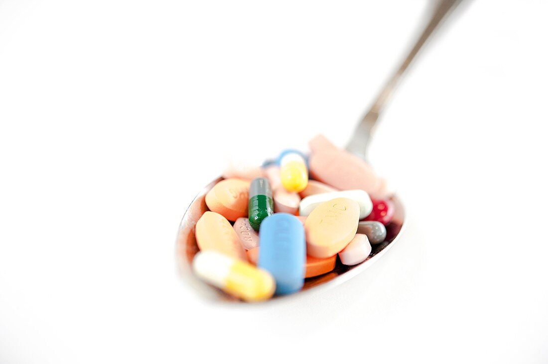Assorted pills on a spoon