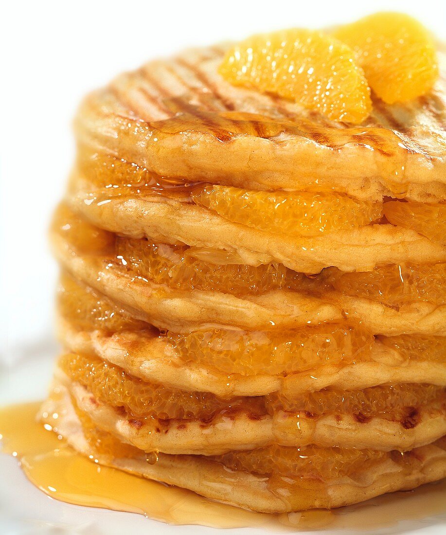 Pancakes with oranges and syrup