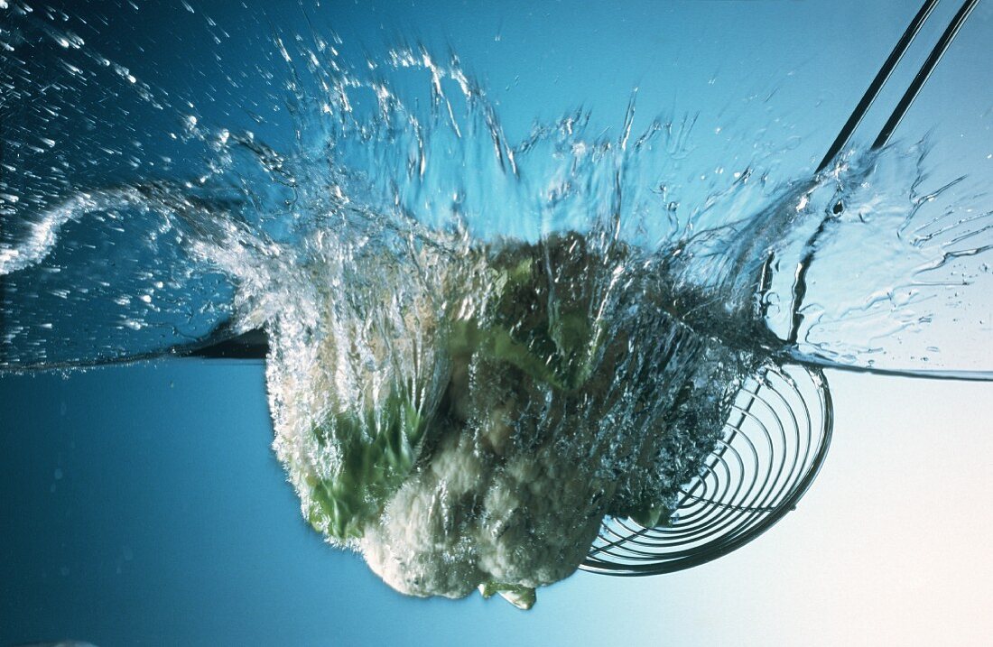 A Head of Cauliflower Falling into Water