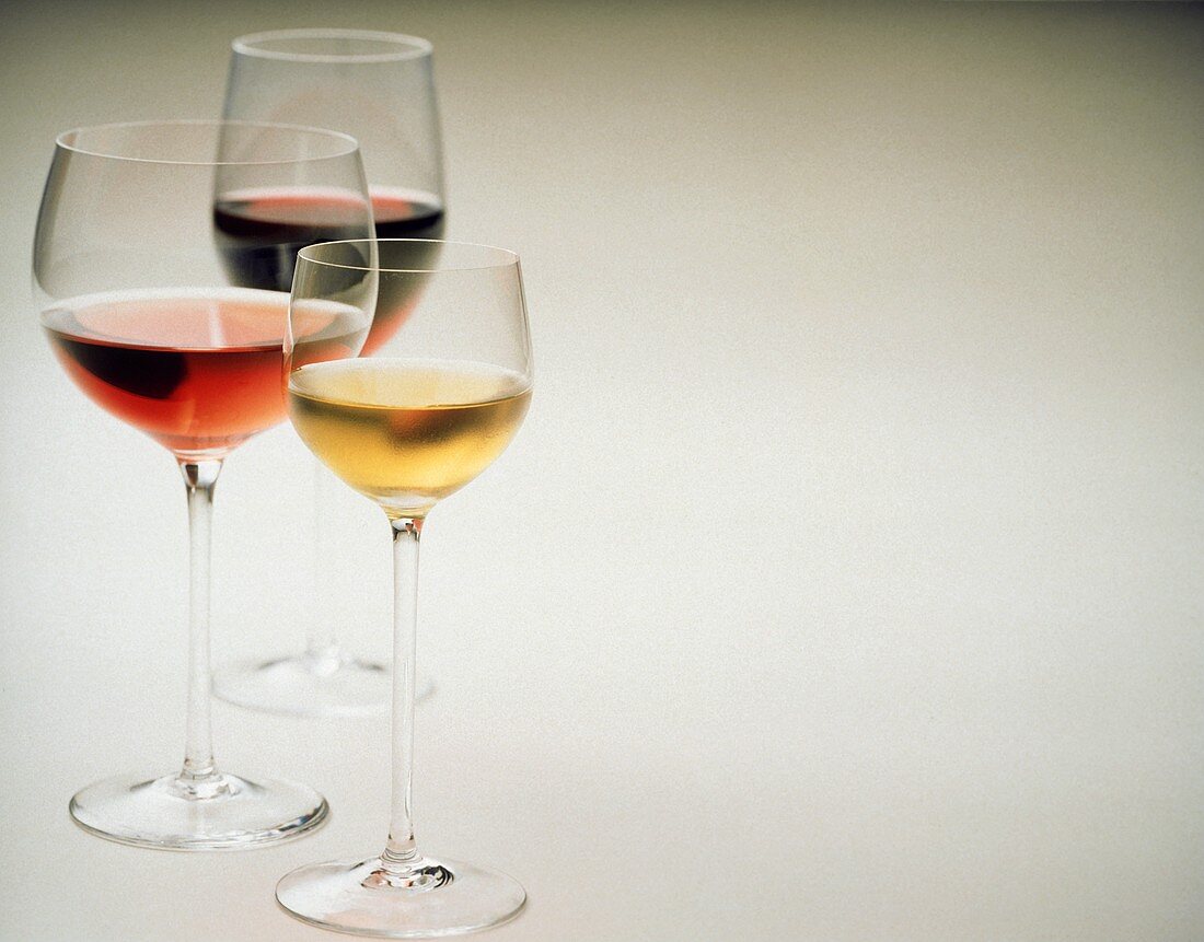 Glass of white wine, glass of rose wine and glass of red wine