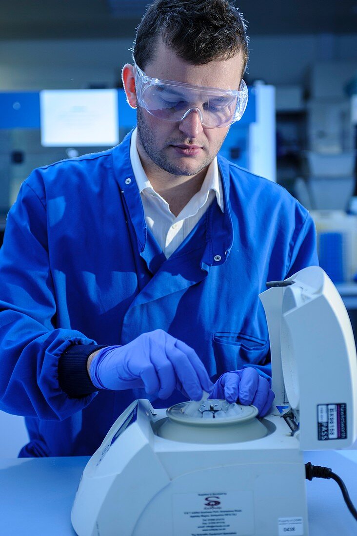 Scientist loading a centrifuge