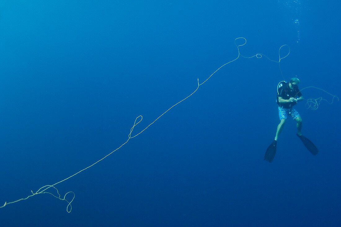 Diver gathering fishing long line