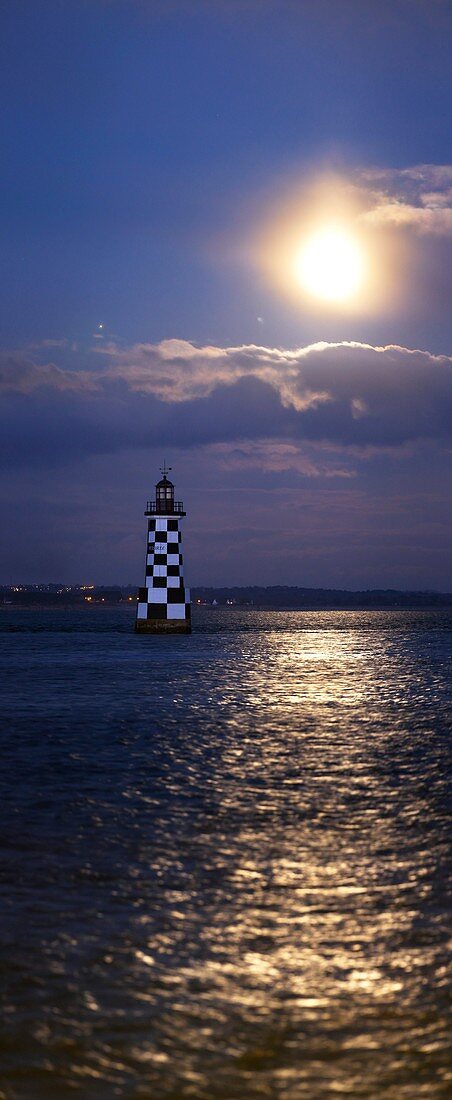 Full moon and Jupiter over a lighthouse