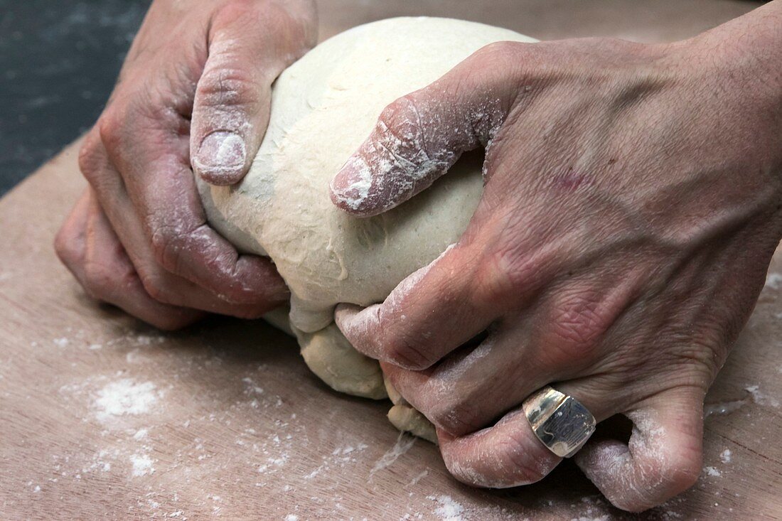 Baker kneads dough