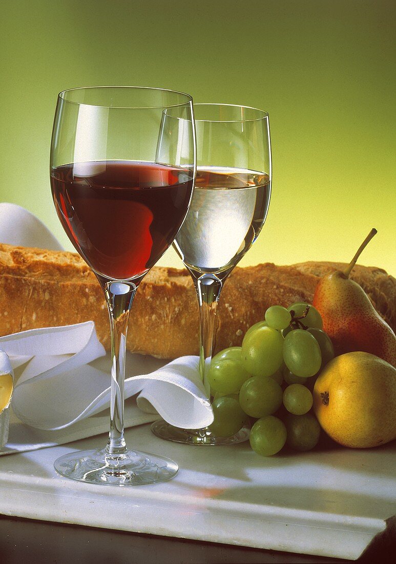 A Glass of Red and White Wine with a Loaf of Bread