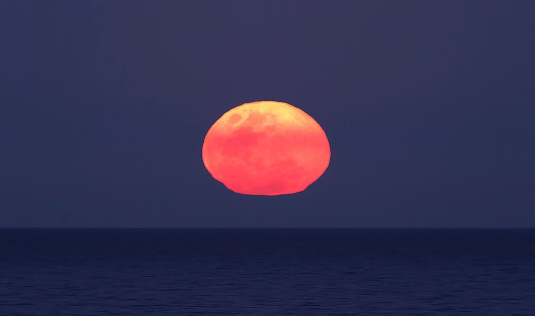 Moon rising over the sea