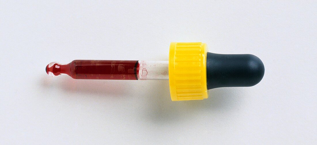 Pipette with red liquid in