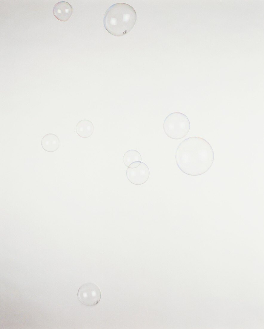 Nine soap bubbles floating in the air