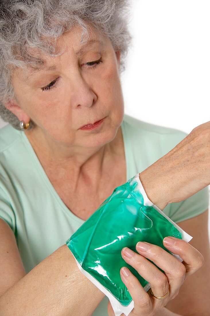 Patient applying a thermal pack