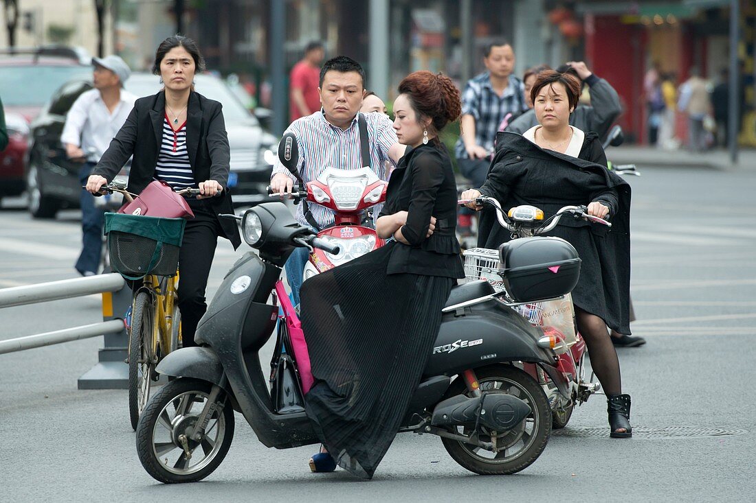 Woman on electric scooter in traffic