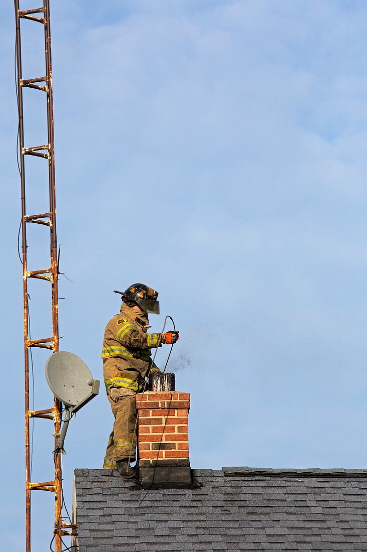 Firefighter fighting a chimney fire
