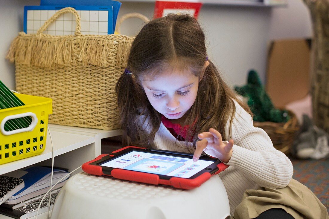Primary school girl using tablet,USA