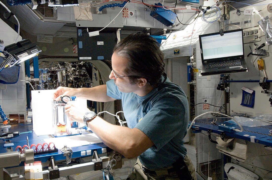 Astronaut conducting experiment on ISS