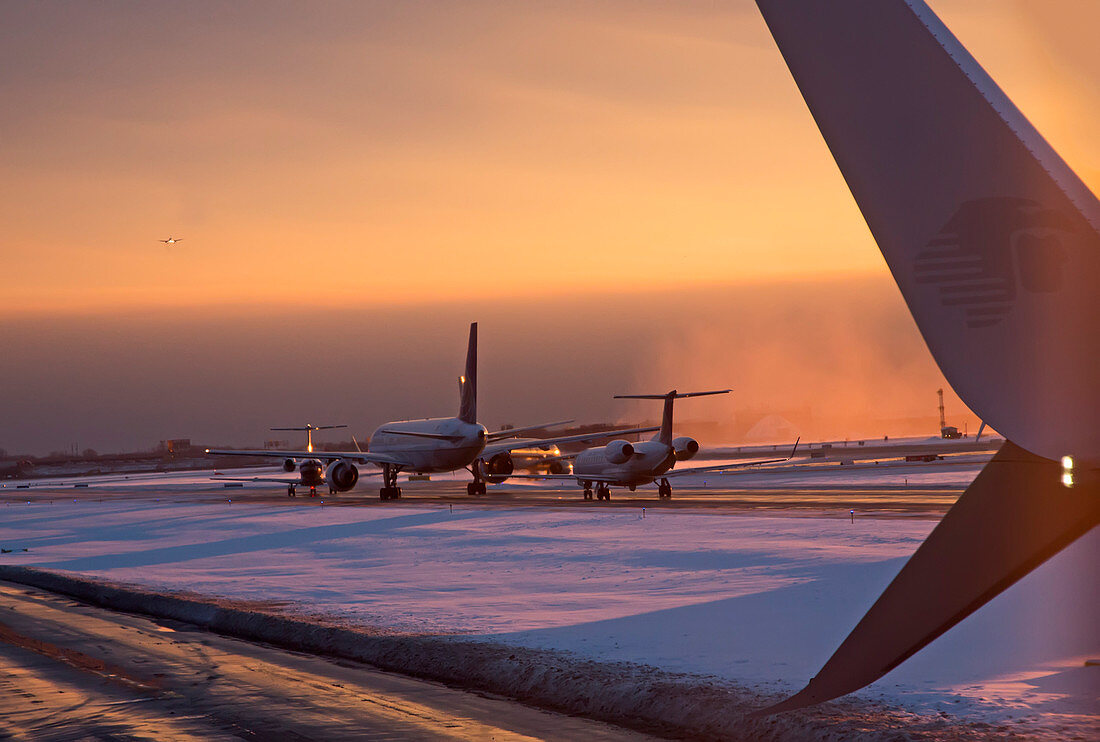 Passenger airliners taxiing at dawn
