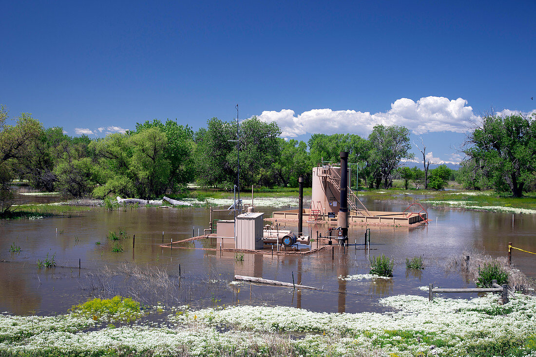 Oil well flooded by river,USA